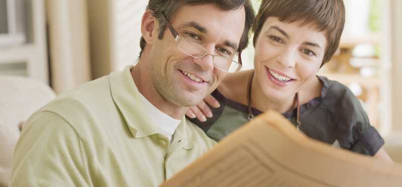 Couple reading the newspaper together.
