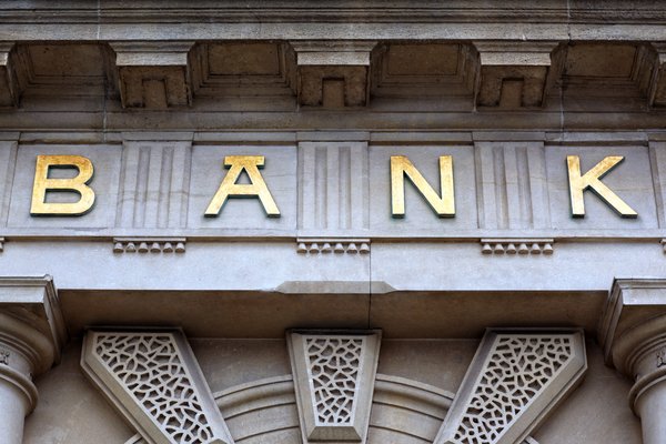 Old cement building with gold lettering that reads BANK.