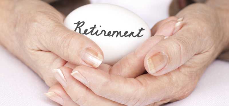 Hands cradling egg with the word Retirement written on it.