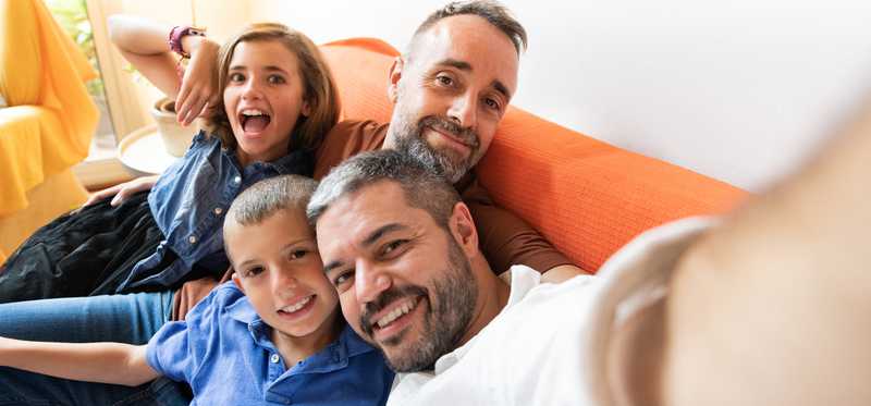 Group of people smiling for selfie.