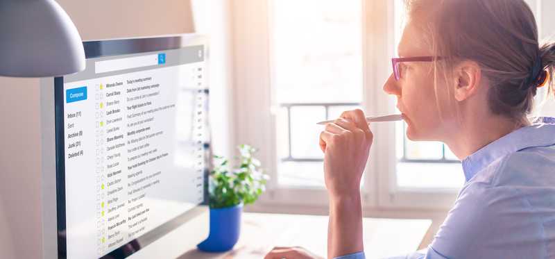 Woman uses desktop computer at home.