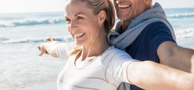 Mature couple enjoying time together on the beach.