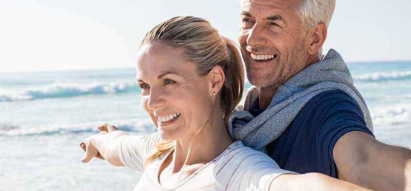 Mature couple enjoying time together on the beach.