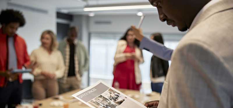 People at a table engaging in commercial real estate planning.