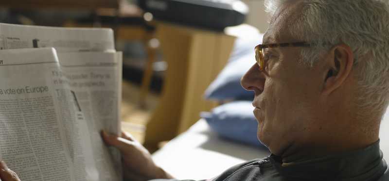 Person reading a newspaper.