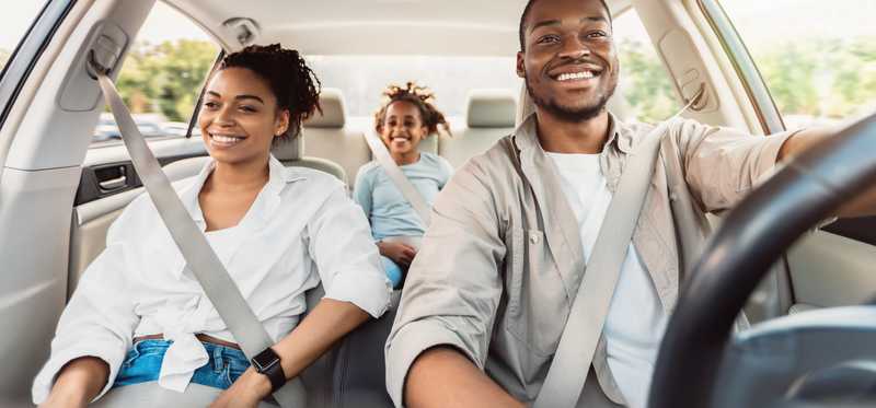 Interior view of three people inside a minivan.