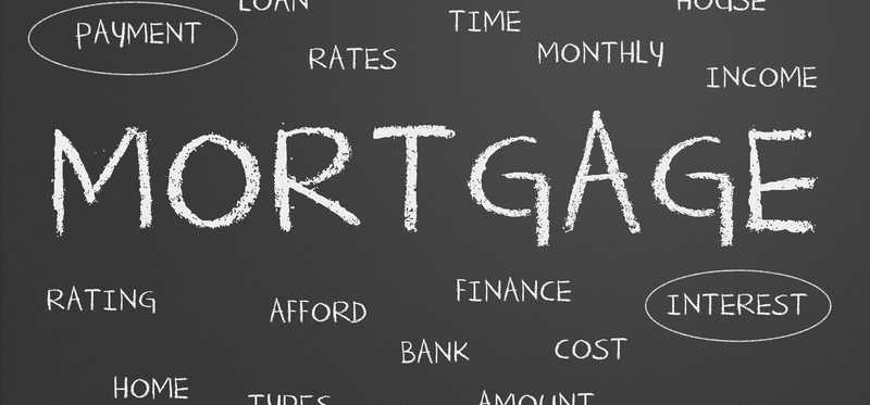 Blackboard with the word mortgage and smaller, related words surrounding it.