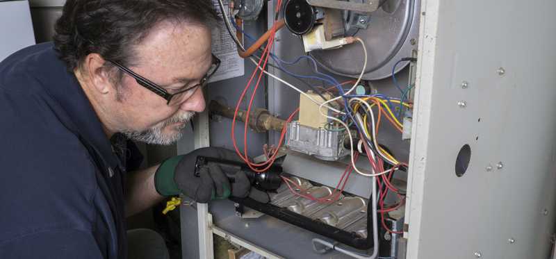 Person repairing a heater.