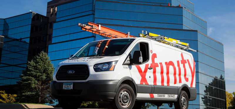 Comcast Xfinity truck in front of Comcast building.