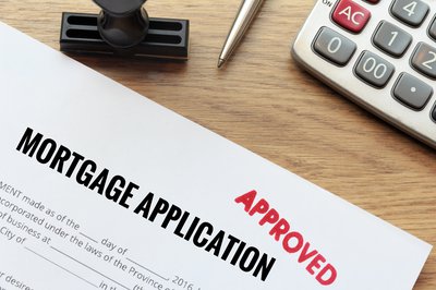 Mortgage application with red Approved stamp.