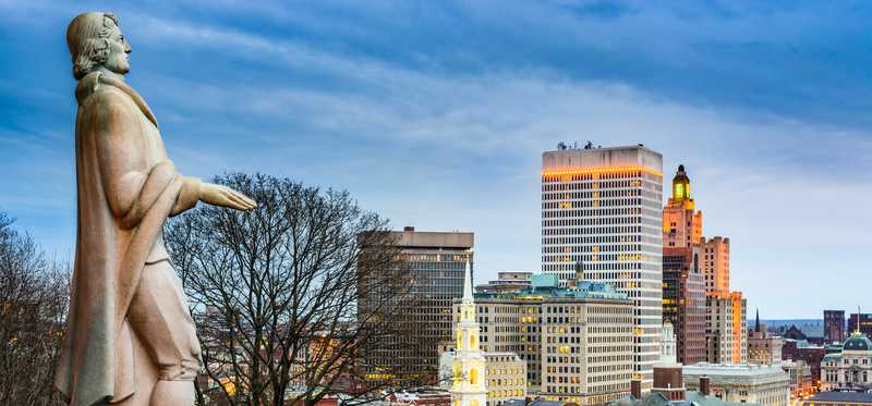 Rhode Island founder Roger Williams statue by skyline.