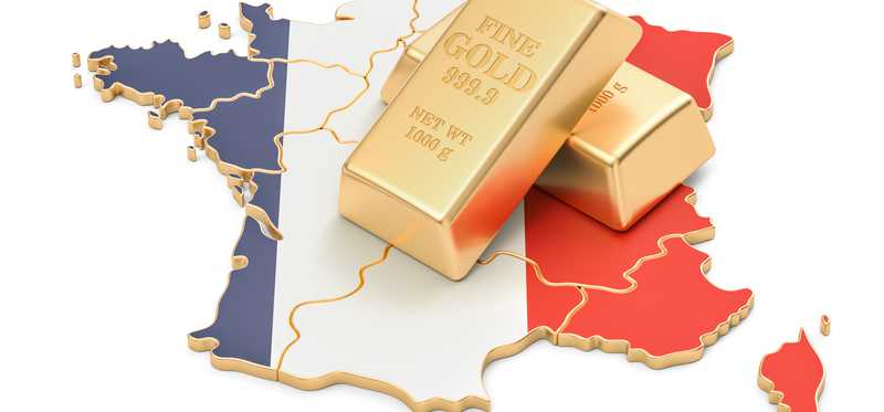 Gold bars sitting on image of France.