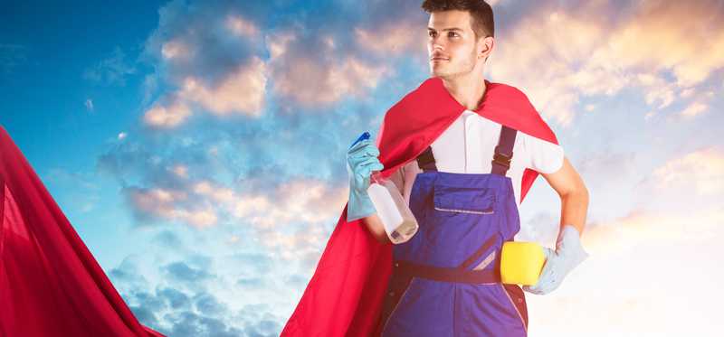 A man with a cape and cleaning supplies