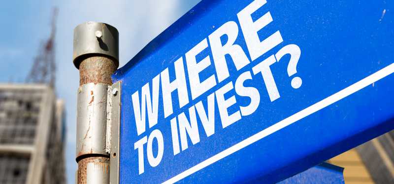 a street sign that reads where to invest