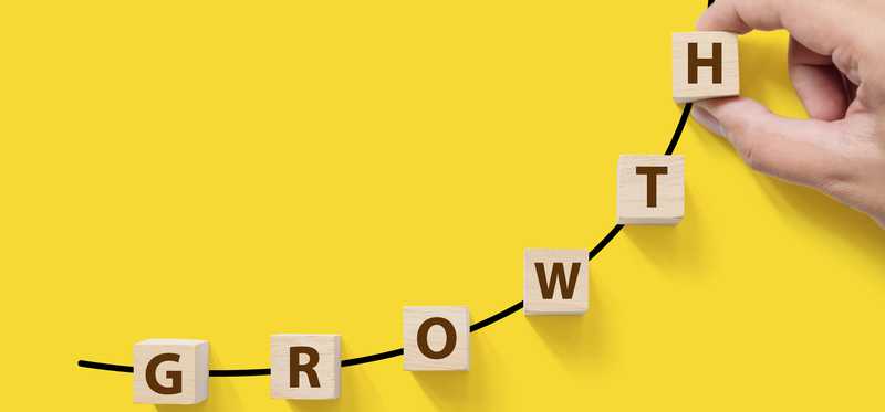 The word Growth spelled out with block aligned on an upward sloping line