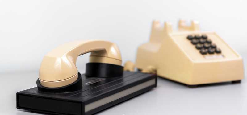 An old modem and rotary phone.