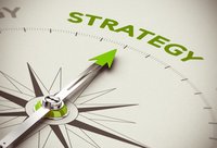 A compass with the arrow pointing to the word Strategy.