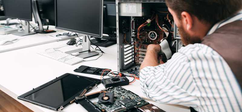 A man fixing a computer.