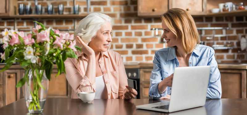 An older and a younger woman having a chat.
