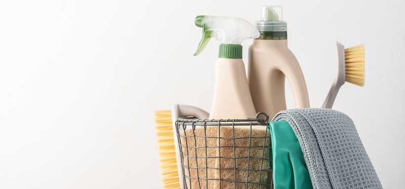 A wire basket containing cleaning supplies.