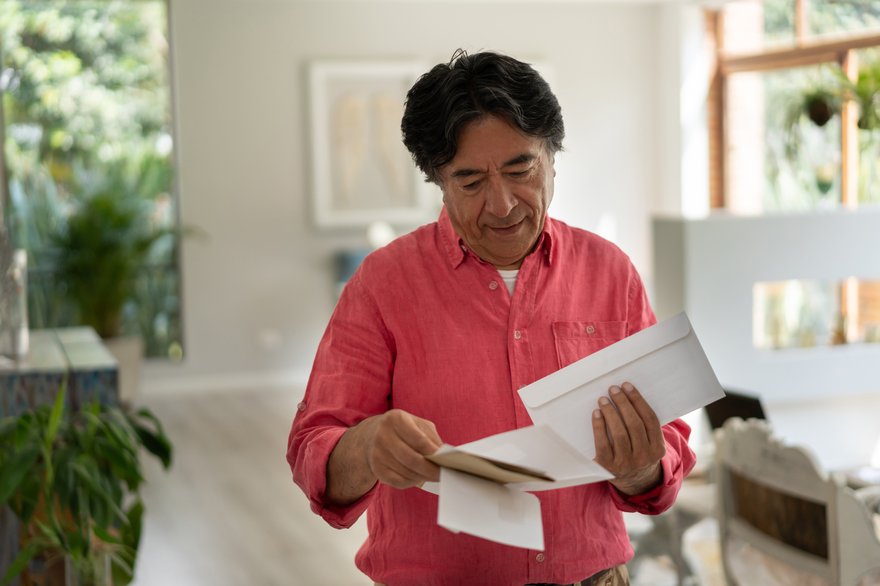 Person standing and looking through mail.