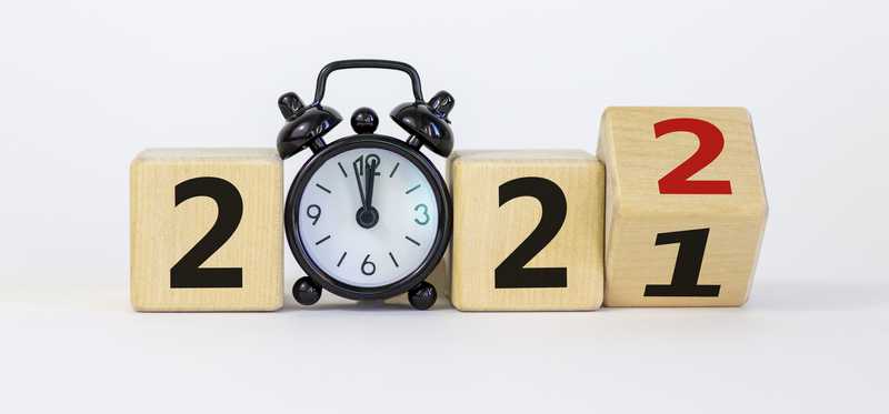 Clock showing the year 2021 turning over to 2022 at midnight.