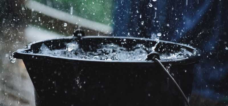 A bucket collecting water in the rain