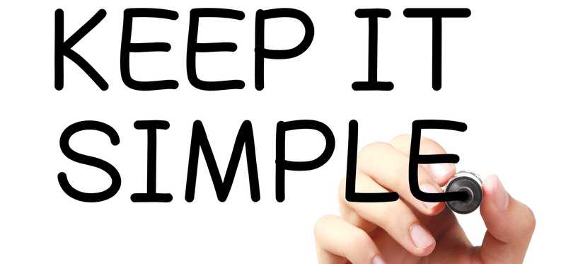 A hand writing the words Keep It Simple