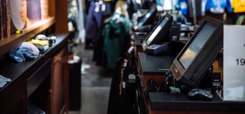 Cash registers at a clothing store with no employees or customers in the picture.
