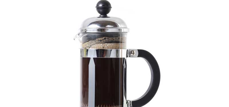 A french press with coffee in it.