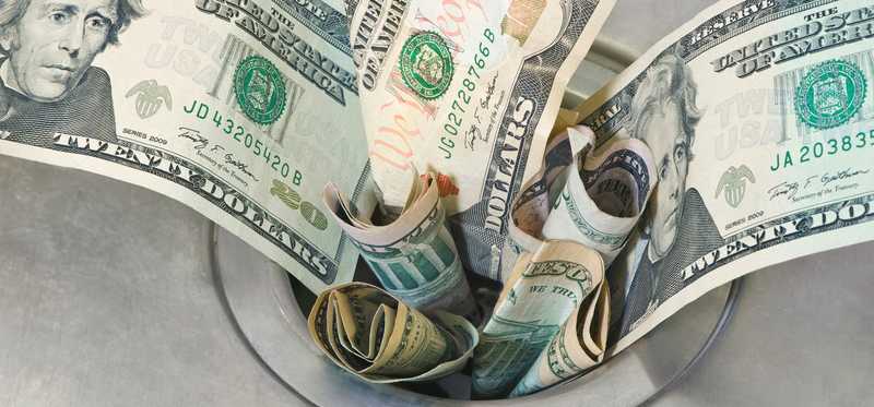 Dollar bills shoved into sink drain