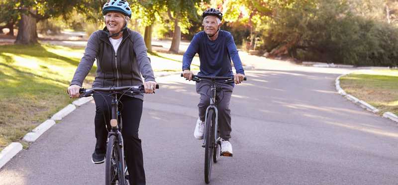 Two seniors on a bike ride.