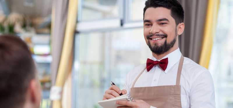 A waiter taking a dining order.