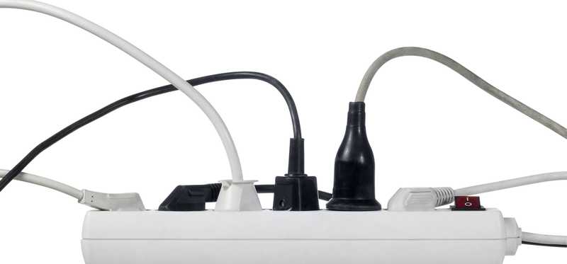 A surge protector with multiple cords plugged in.