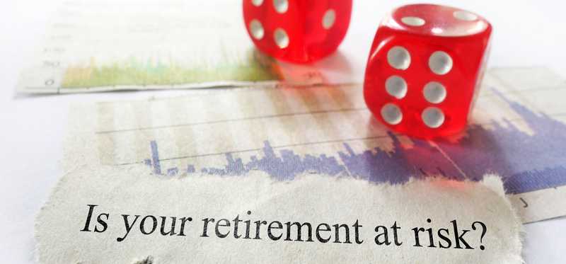 Slip of paper next to red dice reading Is your retirement at risk?