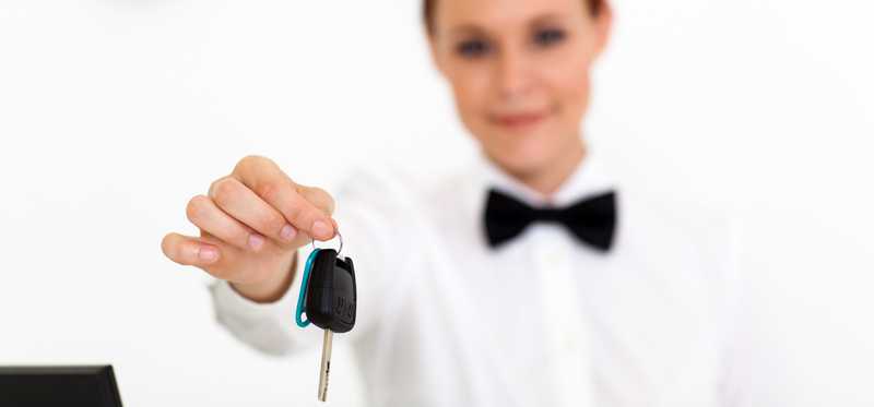 Woman handing over car keys.