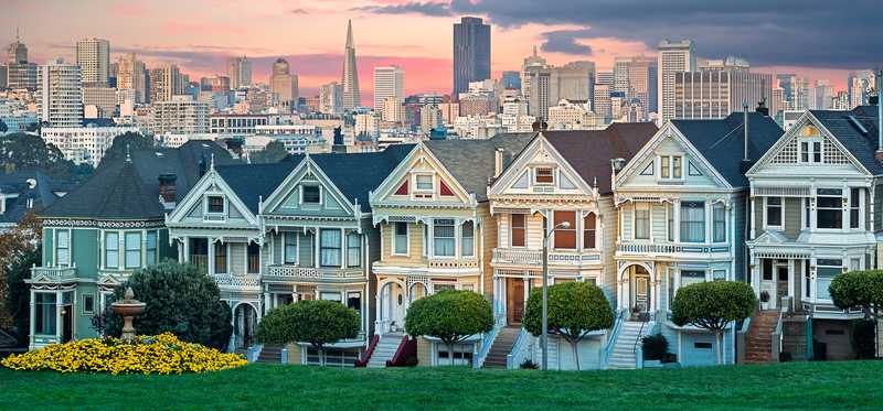 Row of colorful houses by a park in San Francisco.