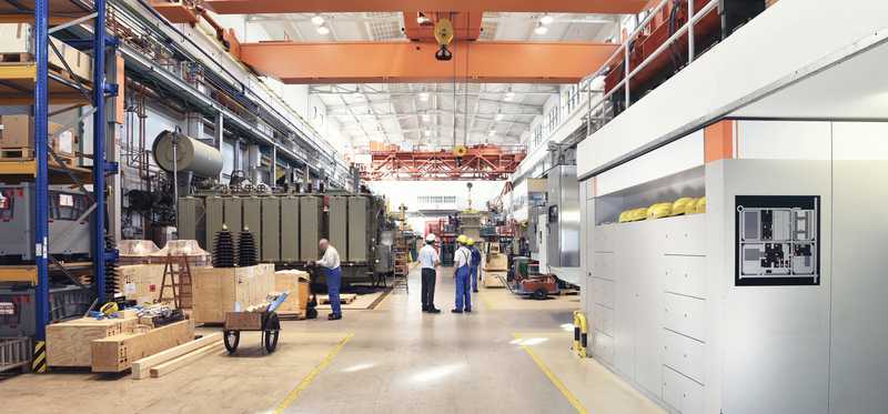 Four people inside a factory.