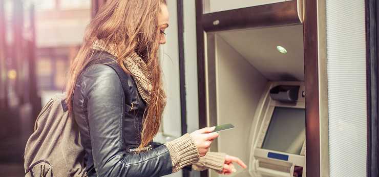 Woman removing funds from an ATM