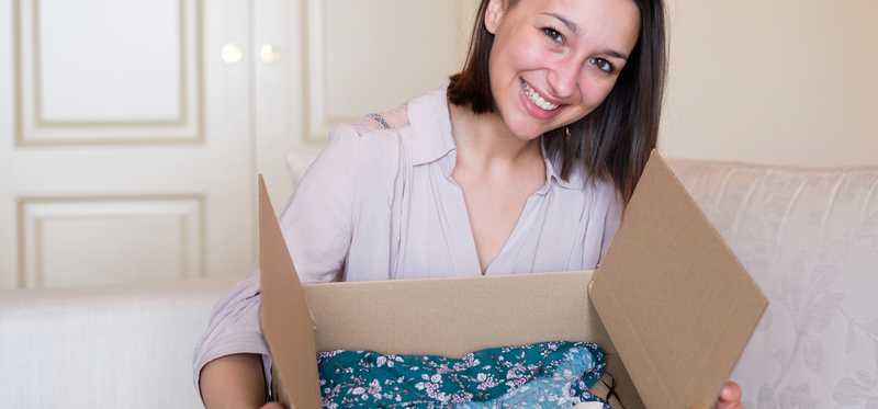 Woman holding a box with clothes in it