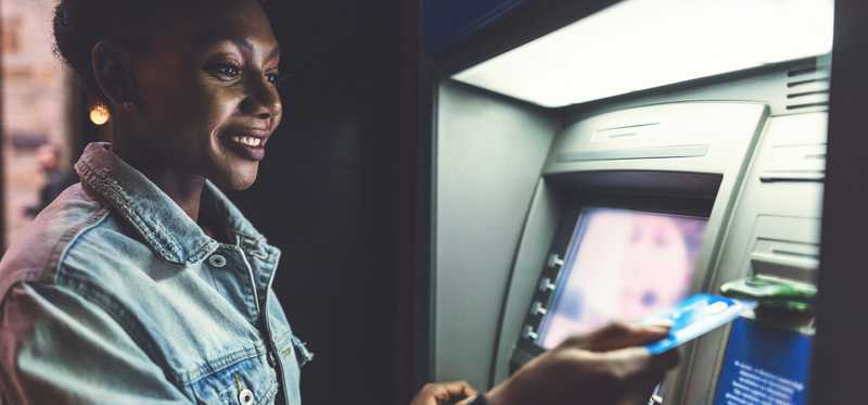 Person making transaction at ATM.