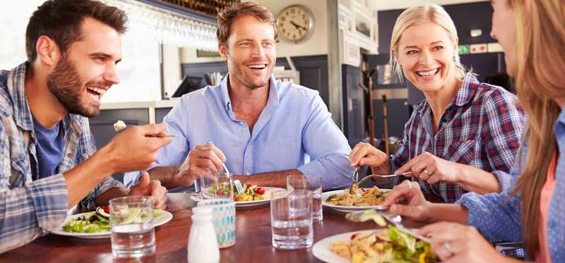 Four friends eating lunch at a restaurant.