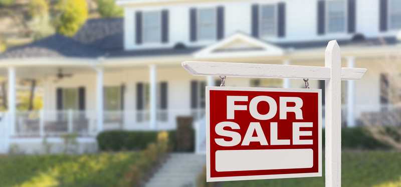 Home with a For Sale sign out front