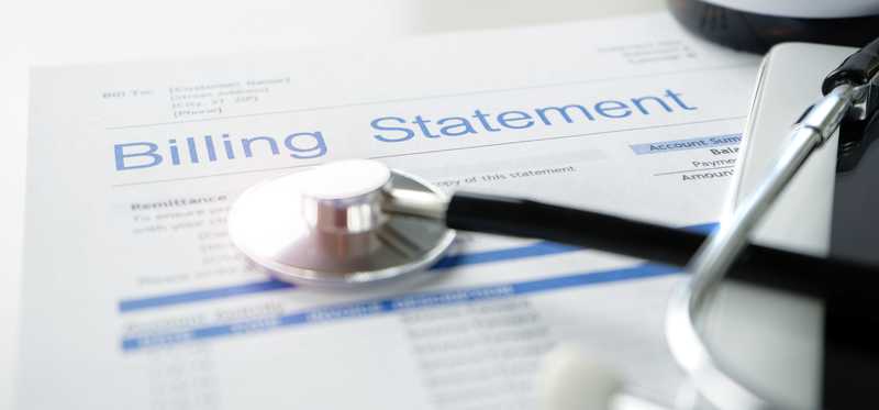 A billing statement with stethoscope laying across the top.