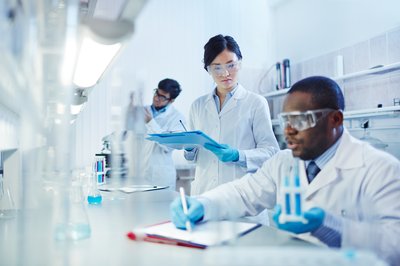 Three scientists working in a lab.