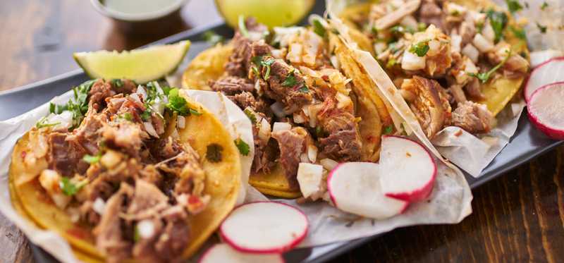 A tray of three tacos.