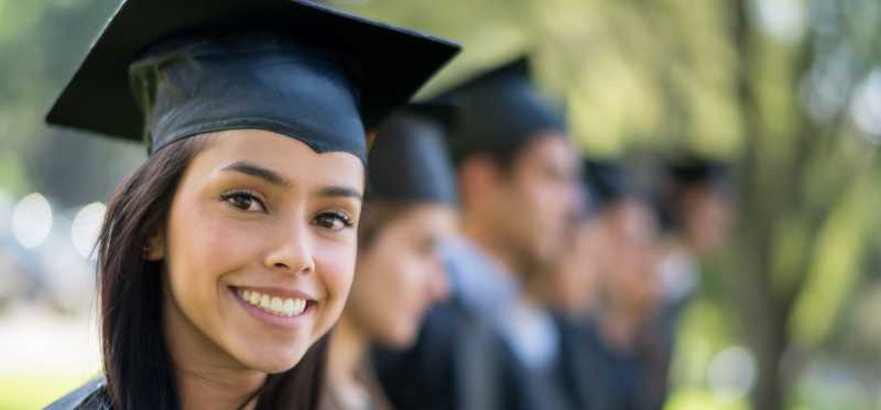 Young woman graduate in cap and gown