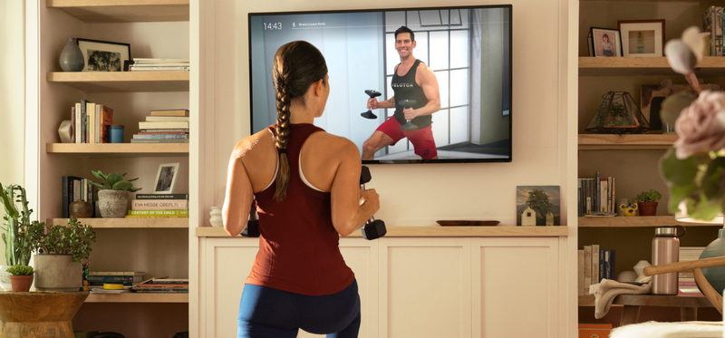 Woman exercising in front of TV