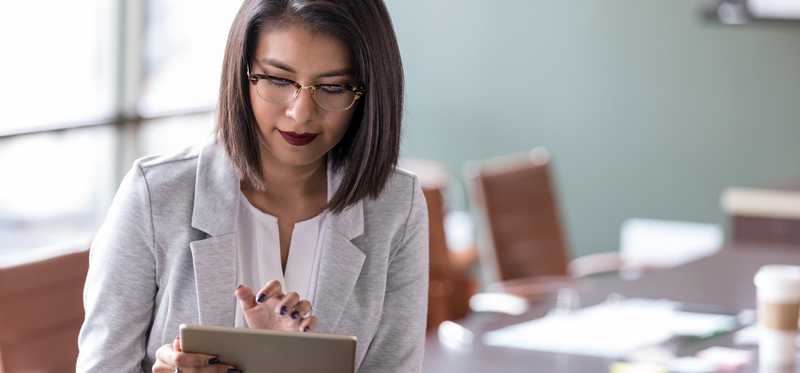 Person using tablet in conference room.