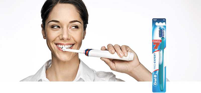 Woman brushing teeth with Oral-B toothbrush